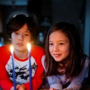 Boy and girl looking at candles