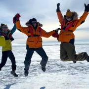Cassandra Brooks, Ulyana Horodyskyj Peña and Zephyr Sylvester jumping in Antarctica