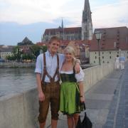 Alums Alex Becker and Kristen Allen don traditional Bavarian clothes with the Regensburg Dom behind them. Photo courtesy of Alex Becker.