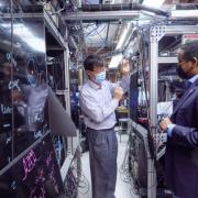 Physicist Jun Ye gives U.S. Rep. Joe Neguse a tour of his lab at JILA on the CU Boulder campus.