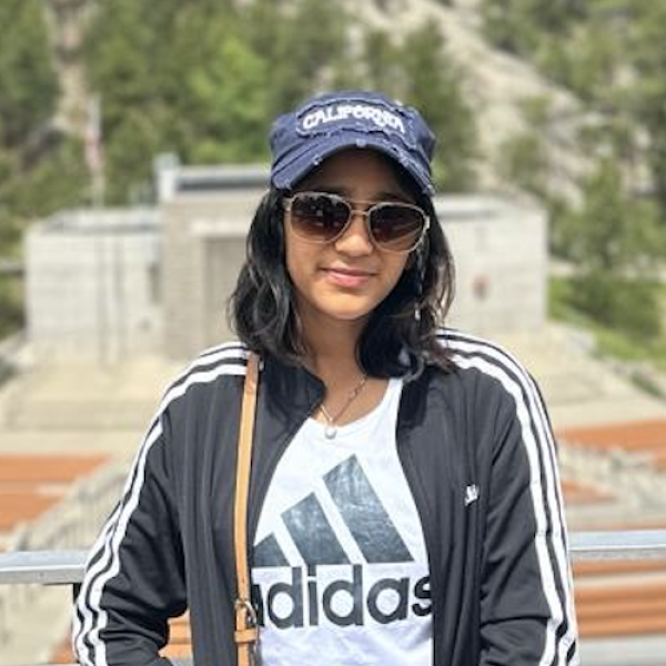 Siddhi Singh wearing sunglasses standing in an open air performance venue