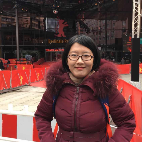 Ziying Zhang stands in front of a theater.