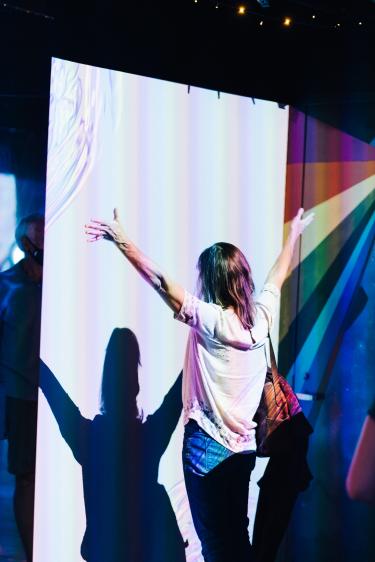 woman dancing in rainbow room
