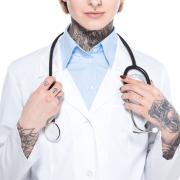 Photo of tattoos person in lab coat with stethoscope 