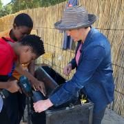 Kari Santos teaches two women to make the peanut roaster.