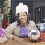 LeeLee James sits in the BTU lab wearing a funny white hat and holding a disco ball