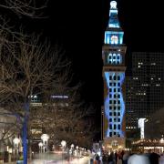 Denver's Daniels and Fisher tower lit up at night.