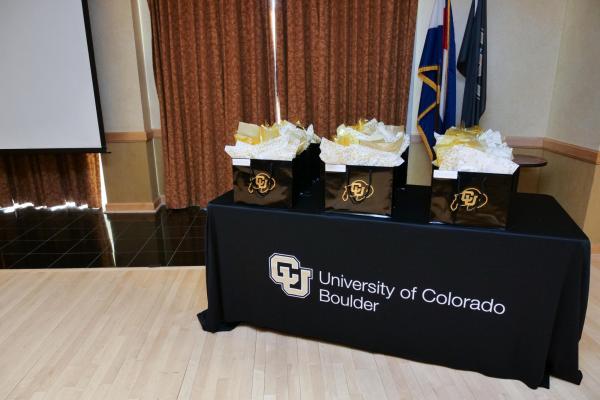 Award gift bags on a CU Boulder table