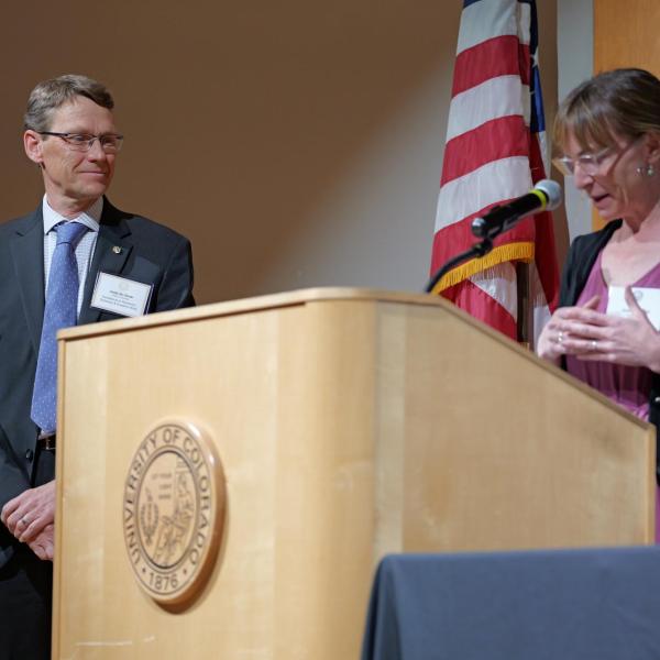 Selection Committee chair June Gruber introduces Excellence in Research awardee Joost de Gouw