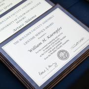 Leadership award winners plaques on a blue tablecloth