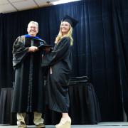 Chair, Carl Koval, congratulating undergraduate student_1