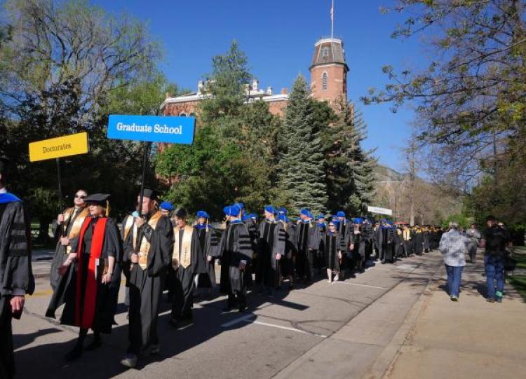 PhD candidates on their way to commencement. New research published this week offers insight into the career trajectories that may await them. (Photo by Glenn Asakawa/CU Boulder)