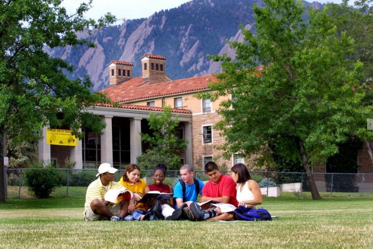 Group of students studying on the lawn on the CU Boulder campus