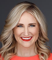 Headshot of Rachel Mario against a gray background.