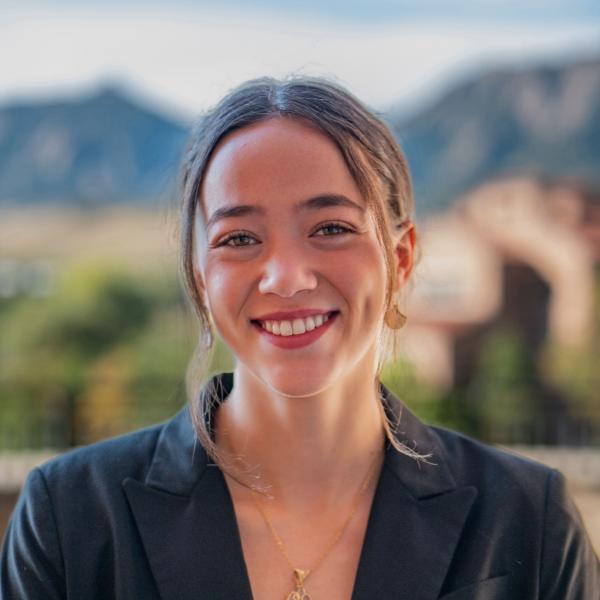 Lola Lichtenstein smiling in front of the Flatirons.