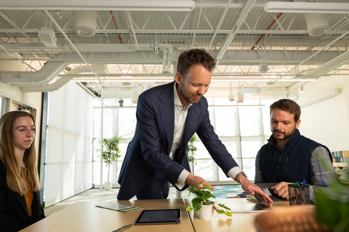 An instructor interacts with students in a classroom
