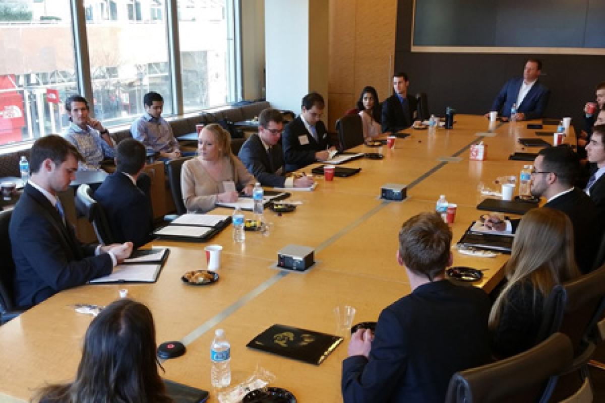 Burridge Center students on a financial trek and sitting in a board room