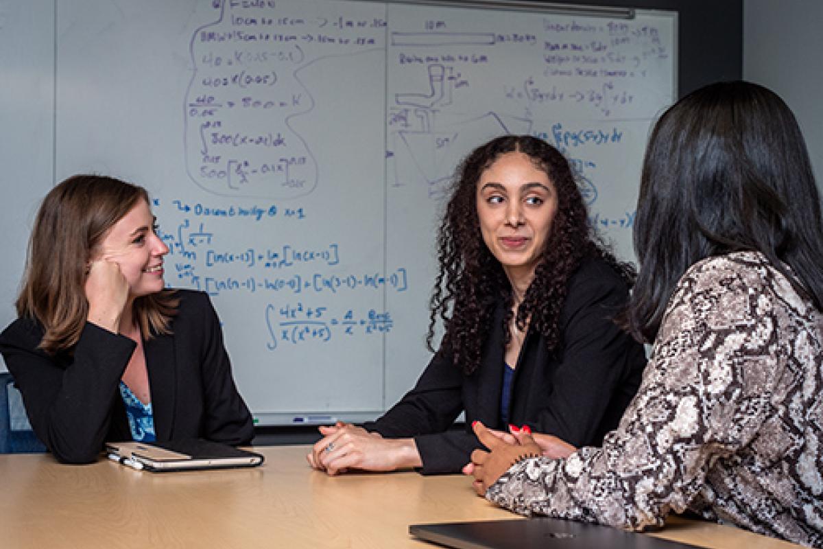 Students have a conversation around a title.