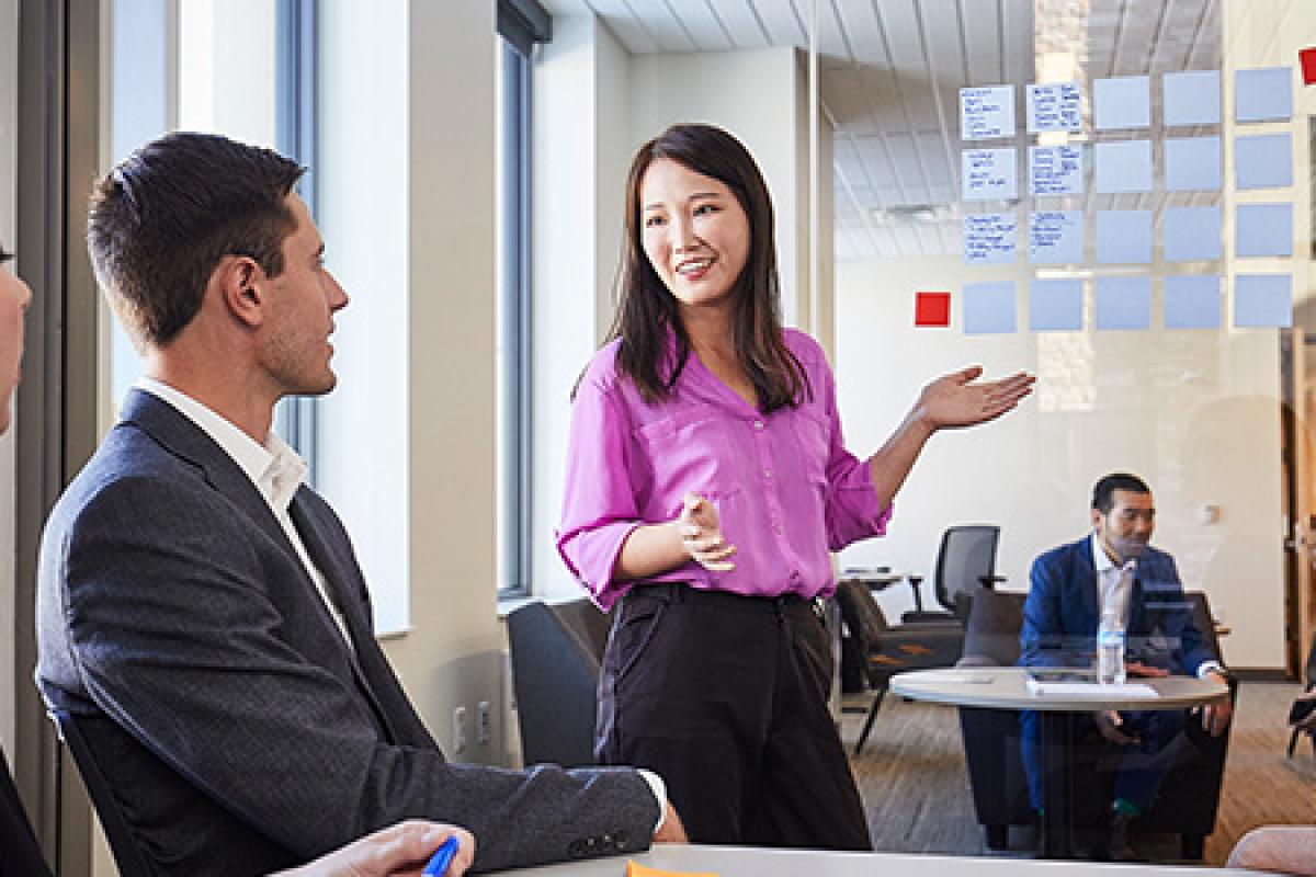 Full Time MBA students meeting with a faculty member