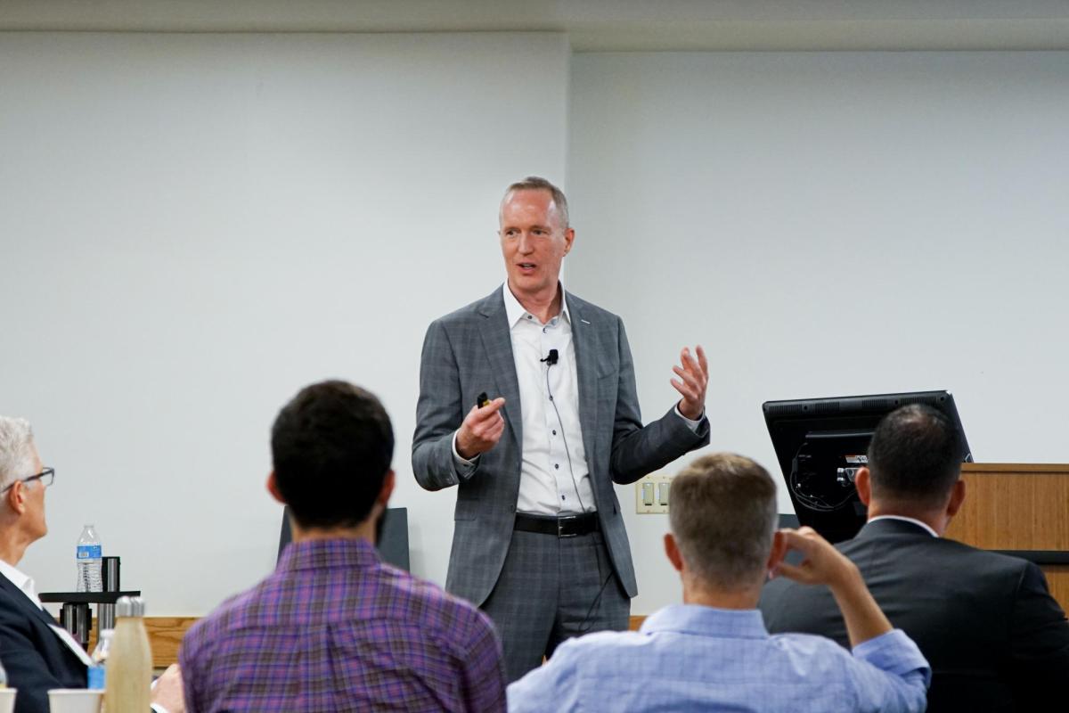 Leeds faculty member speaking to students and corporate partners at an event