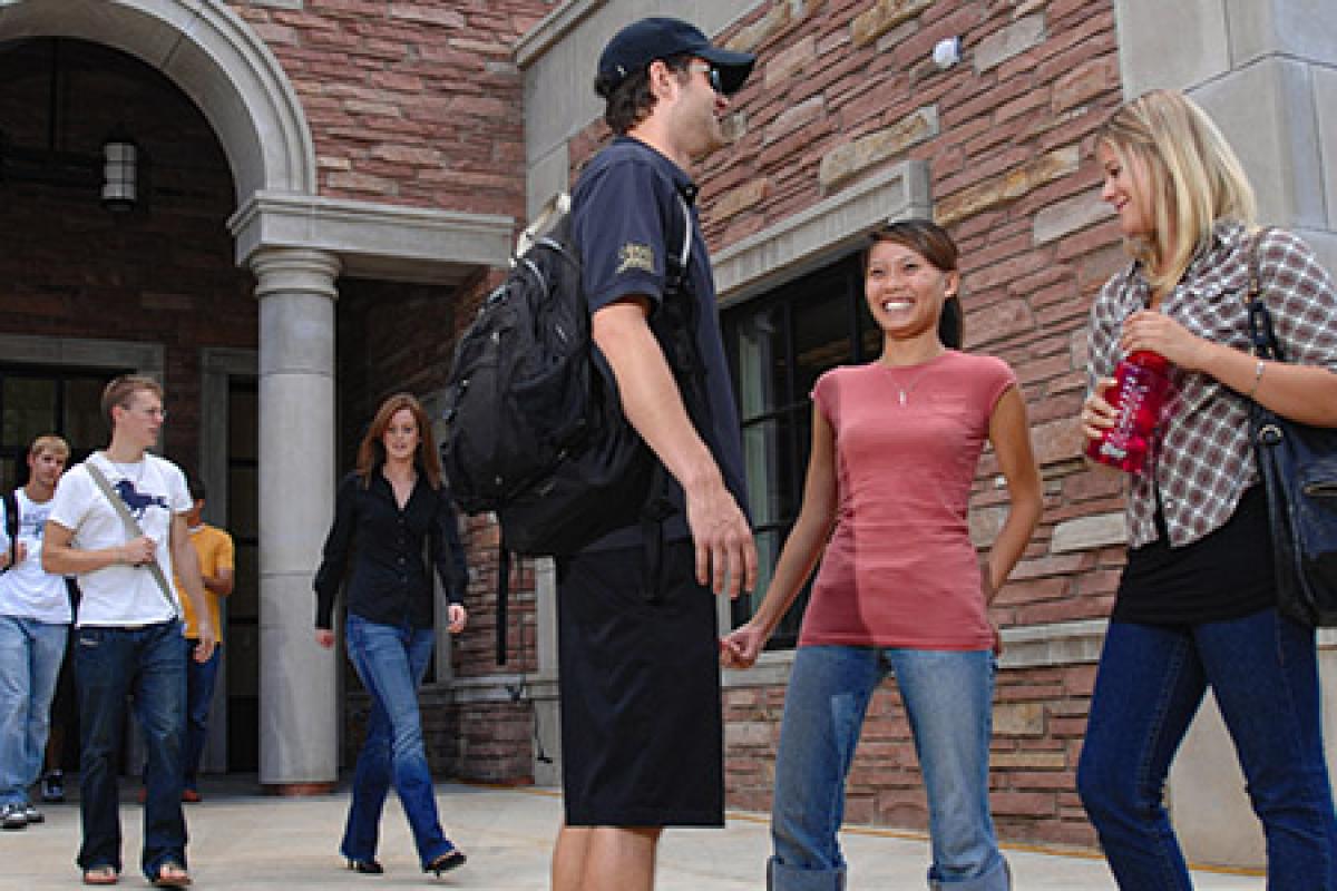 Business school students talking about the Pre-Business program near the Leeds building