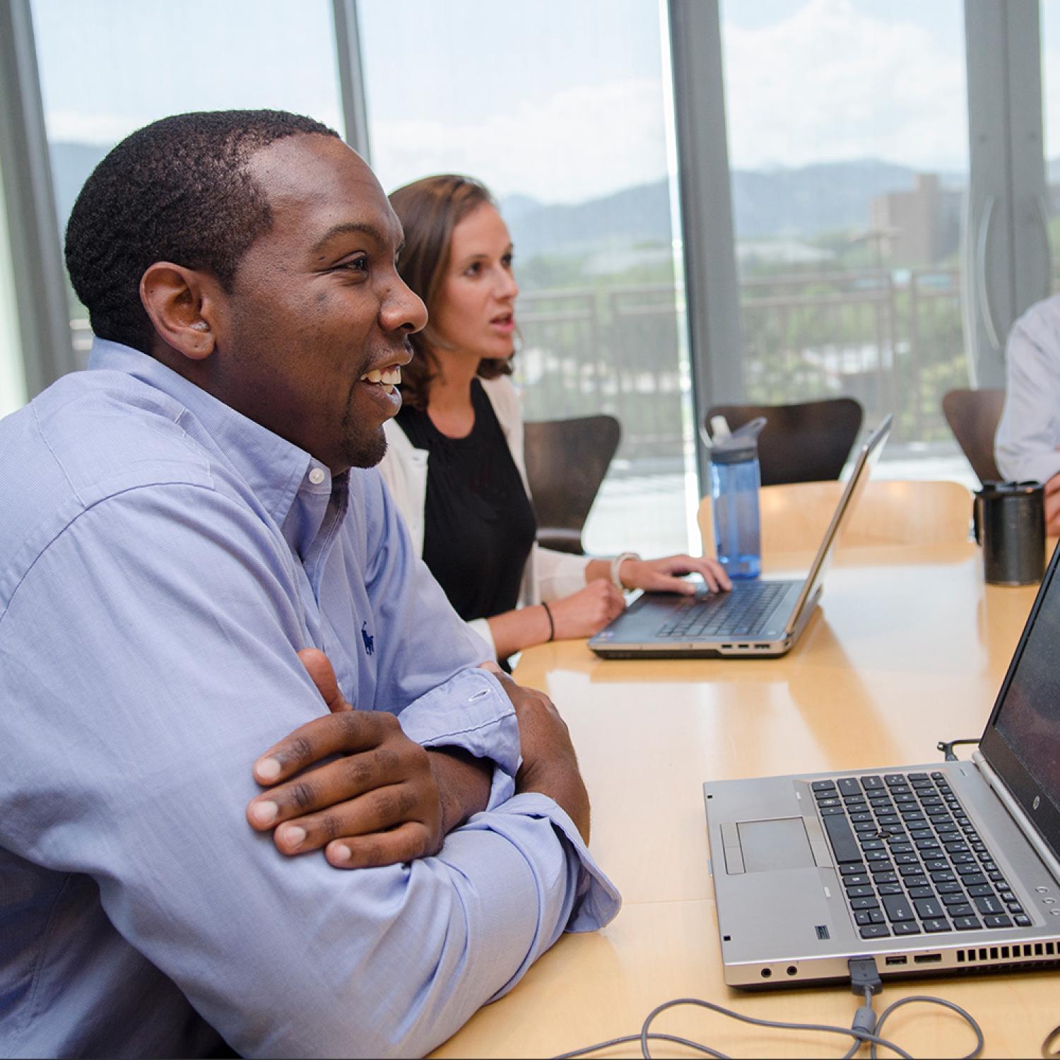 Student engaging with other students in conversation