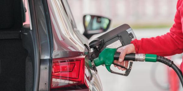Person pumps gas into their car