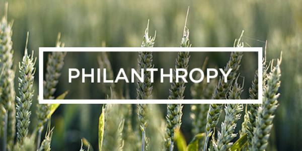 the word Philanthropy against rows of wheat