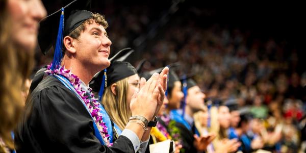 Students clapping in regalia during the Leeds Undergraduate Graduation Ceremony