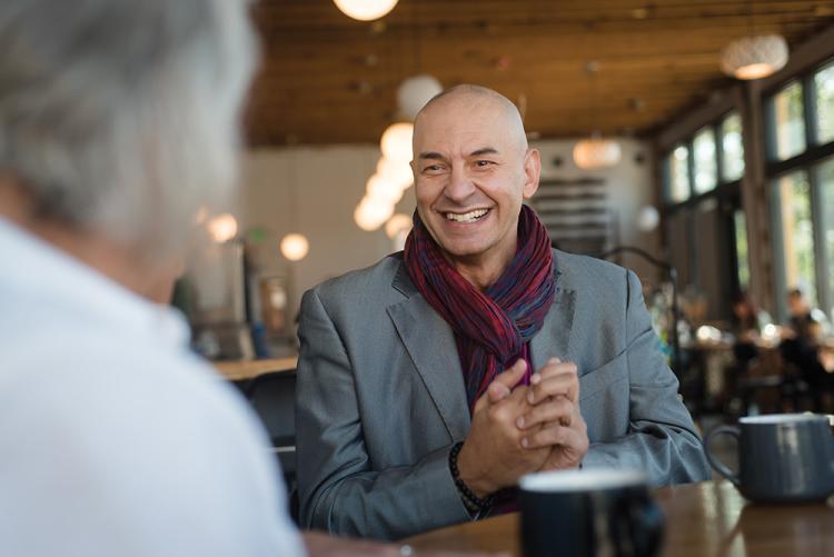 Antonio Papuzza laughs while in conversation with a friend.