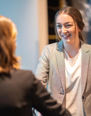 Student speaking at Social Responsibility and Ethics Certificate event.