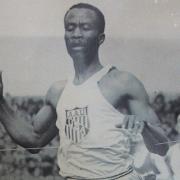 A black-and-white photo of David Bolen running on a track.