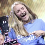 Claire McCollough celebrates with the trophy at the Alteryx competition.