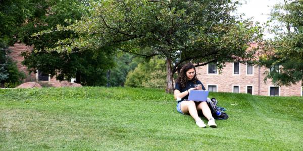 student studying in the grass