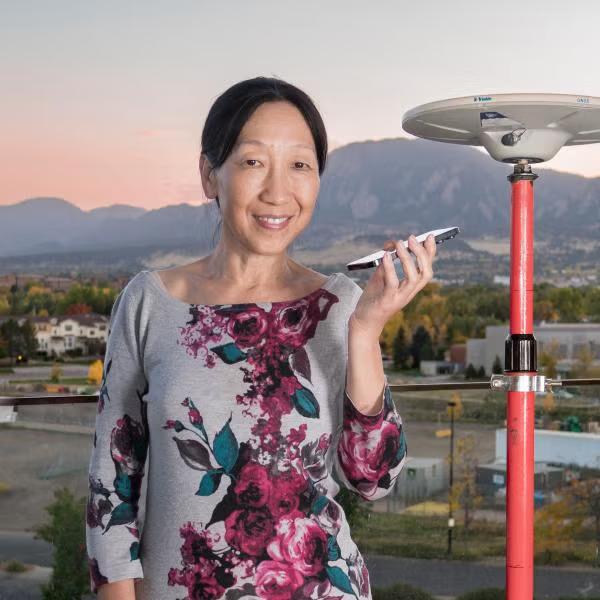 Jade Morton with a phone and monitoring station.