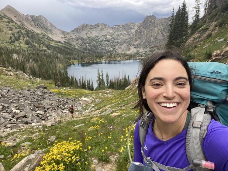 Meg Parker in front of an alpine lake.