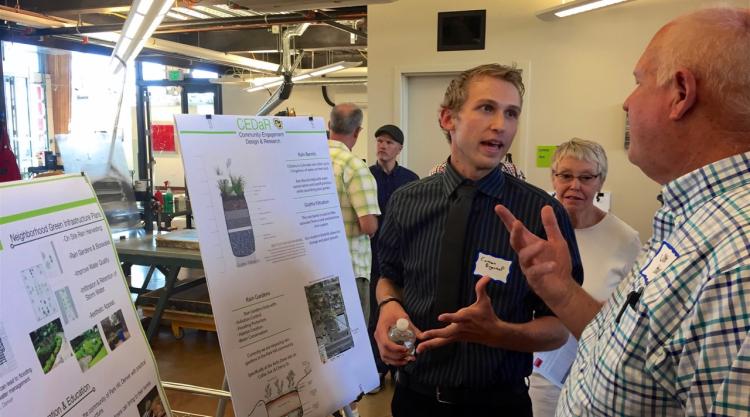 A student explains his project to a neighborhood resident at the Spring 2017 MetroLab event.