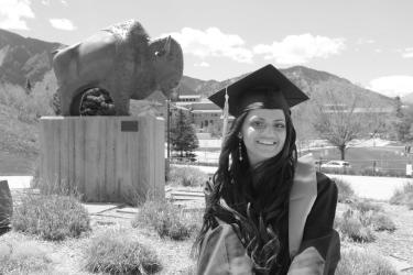Ayushi Patel in front of a CU Boulder statue of a buff.