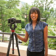 Nandi standing by a camera