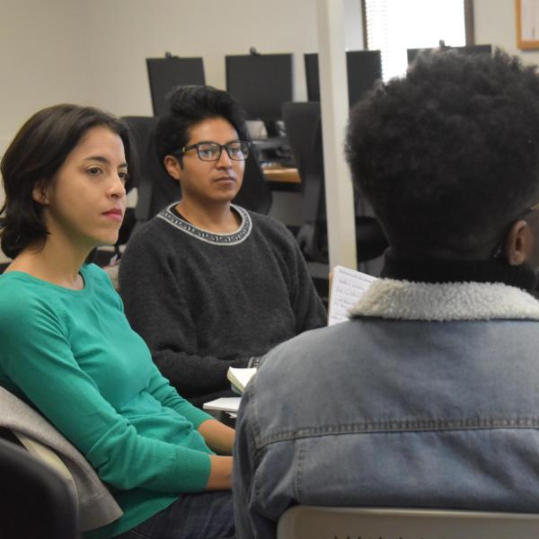 students speaking around a table