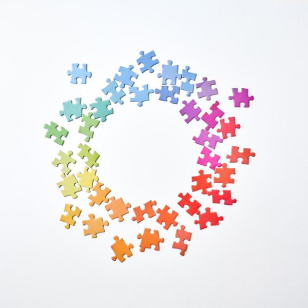 rainbow colored puzzle pieces form a circle