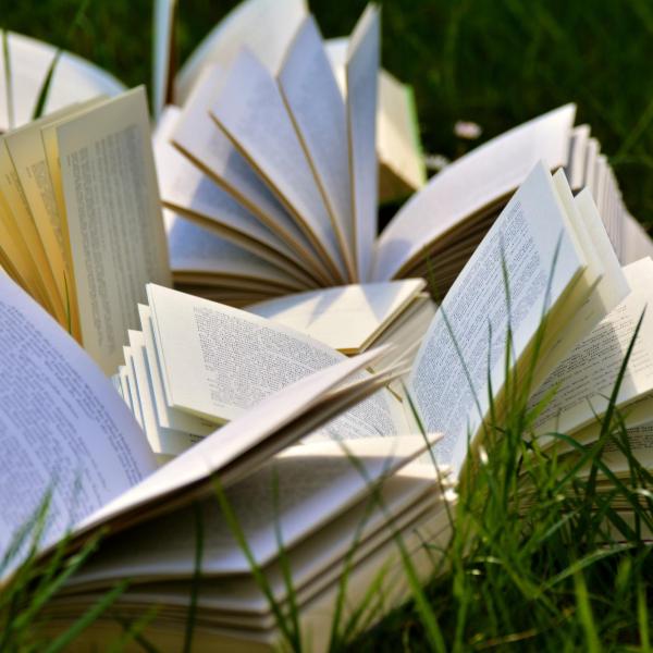 books laying open in the grass