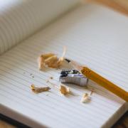 A pencil and pencil shavings rest on a notebook. Photo by Angelina Litvin via Unsplash