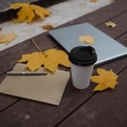 Fall Intensive leaves with a computer and coffee