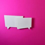 two chat bubbles floating over a pink background
