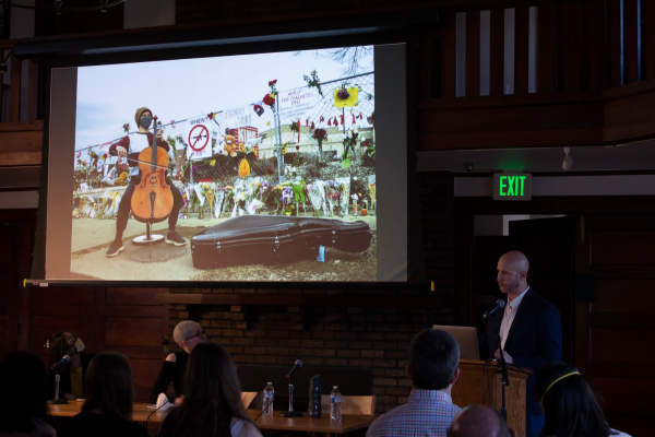 Ross Taylor presenting photo of cellist performing at Boulder shooting memorial 