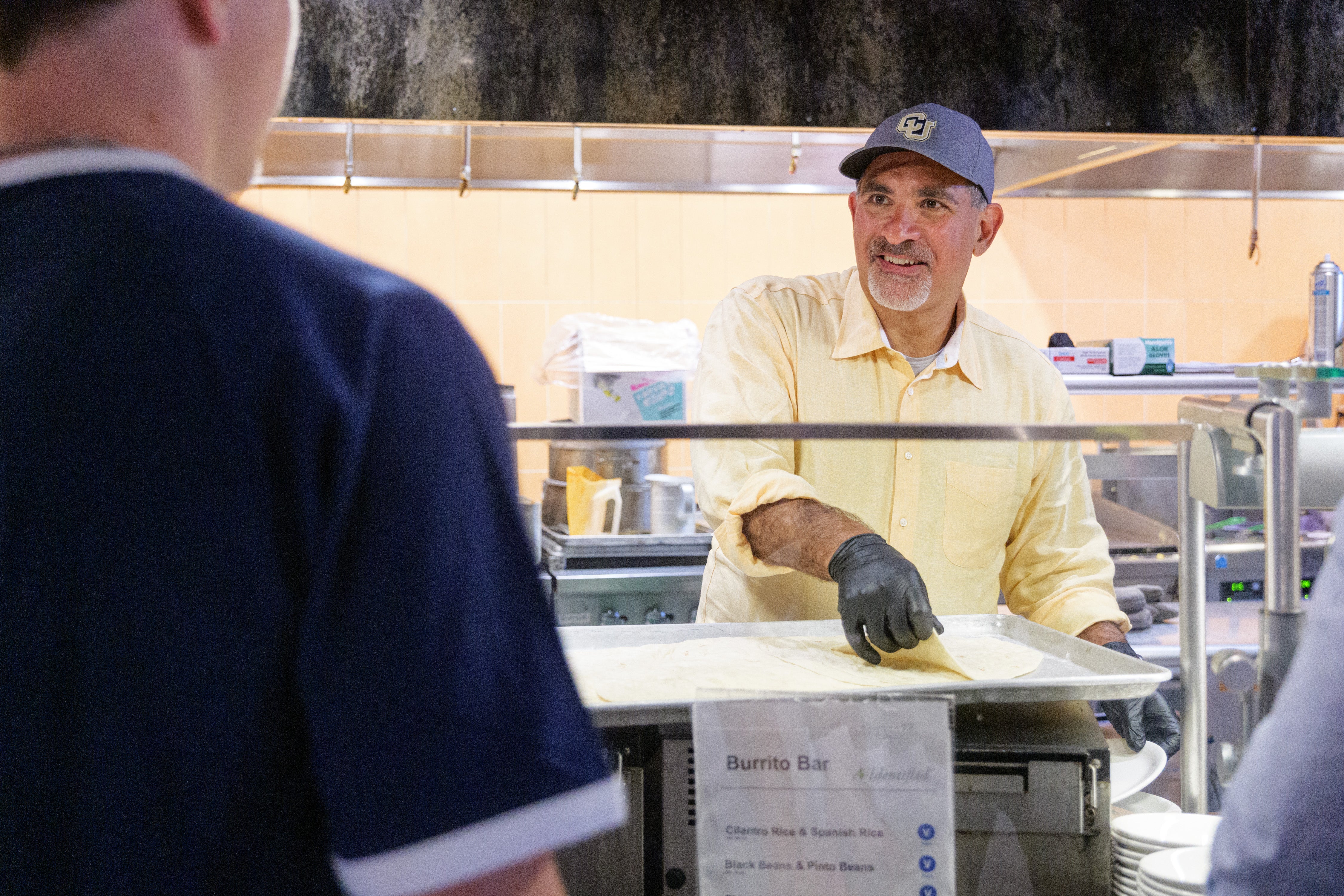 Chancellor Justin Schwartz serving meals at the C4C