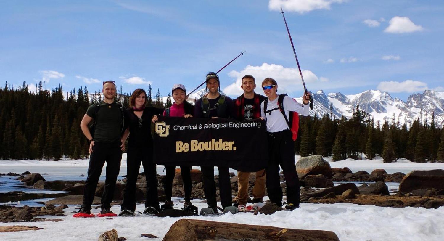 AIChE chapter members on a hiking trip with a CU Boulder banner