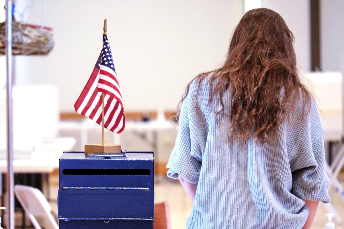 Student at a voting box.