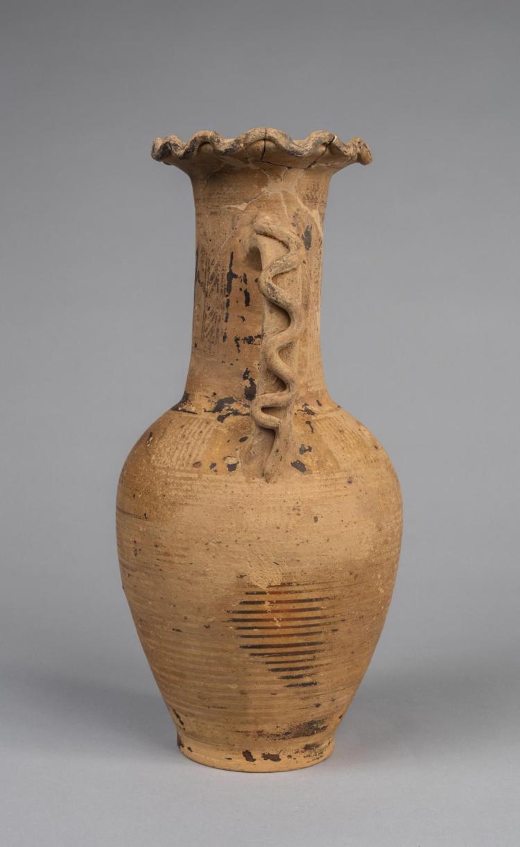 Photograph of side of yellowish-tan amphora against neutral gray background.
